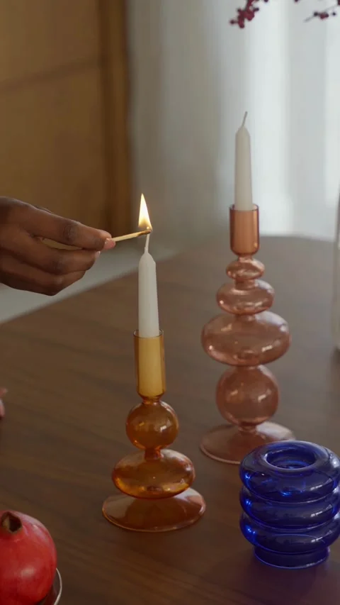 Hand lights a white candle with a small match 스톡 동영상 331769820