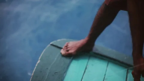 Hand line fishing from a boat in the ocean by local man on Maldives island Stock Footage