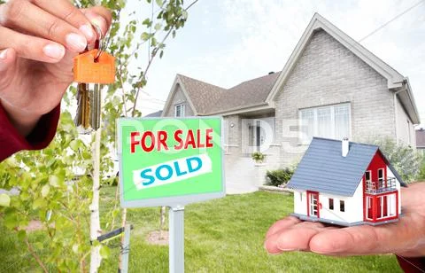 Hand with a little house and keys. Stock Photos