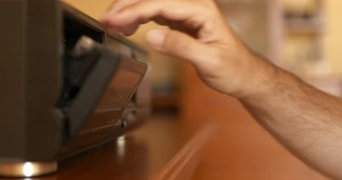 Hand loading an audio cassette tape into a tape recorder Stock Footage 205886880