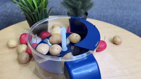 Hand Loading Potatoes into Blue Kitchen Food Processor for Slicing Prep Video stock 325832395