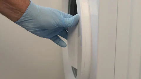 A Hand Loading the Washing Machine with Clothes. A Housekeeper Putting Dirty Vídeos de archivo 307670481