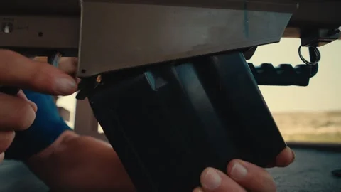Hand loads bullet clip into 50 caliber hunting shotgun before pulling the Video stock 282172631