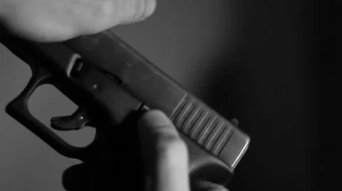 A hand lock a gun bolt Stock Footage 40796299