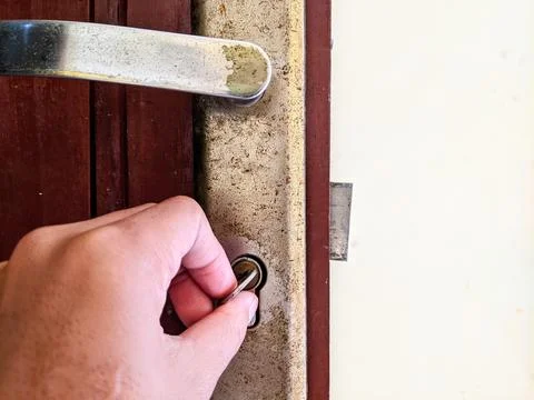 Hand locking the door Stock Photos