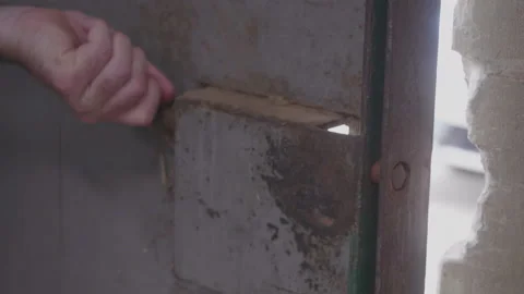 Hand Locking An Old Metal Warehouse Door Stock Footage 219446799