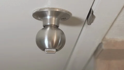 Hand locking a privacy doorknob, someone shaking it trying to get in Stock Footage 101268953