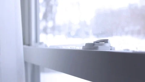 Hand locks window latches in ambient white room Stock Footage 73363005