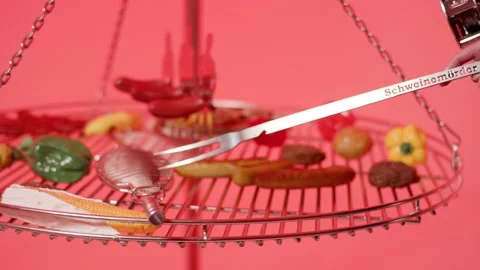 Hand with Long Grill Fork over Round Barbecue Grate, Red Studio Scene Stock Footage 341514465