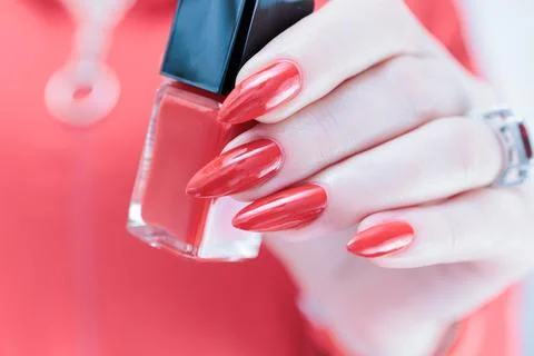 Hand with long nails and a bright red manicure Stock Photos