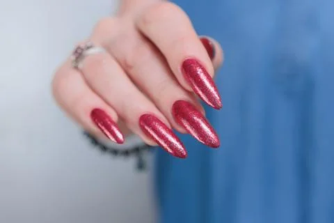 Hand with long nails and bright blue manicure Stock Photos