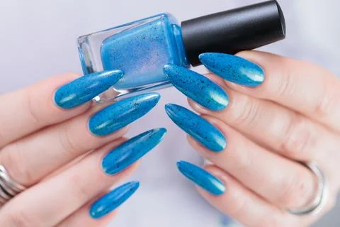 Hand with long nails and bright blue manicure Photos