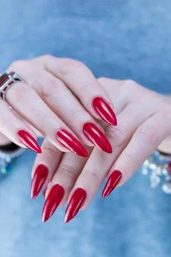 Hand with long nails and a bright red manicure Stock Photos