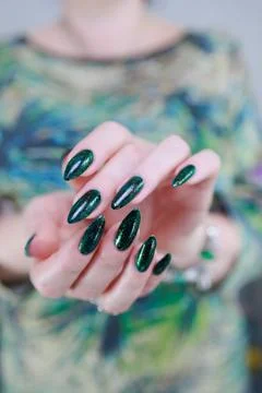 Hand with long nails and dark green nail polish Foto stock