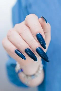 Hand with long nails and dark blue manicure 스톡 사진