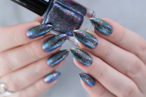 Hand with long nails and a gray silver manicure Stock Photos
