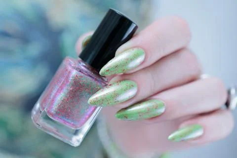 Hand with long nails and light green manicure Stock Photos