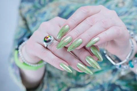 Hand with long nails and light green manicure Stockfoto's