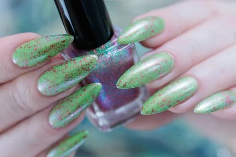 Hand with long nails and light green manicure Stock-Fotos
