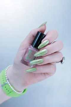 Hand with long nails and light green manicure Stock Photos