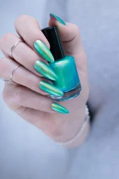 Hand with long nails and light green and blue turquoise manicure Stock Photos