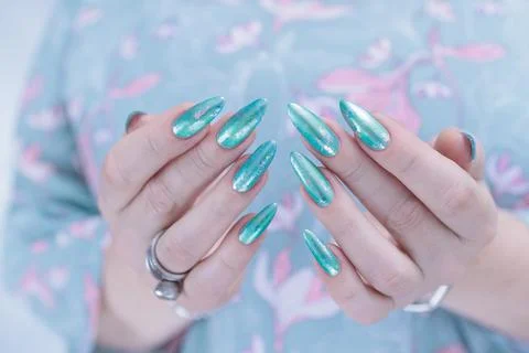Hand with long nails and light green and blue turquoise manicure 스톡 사진