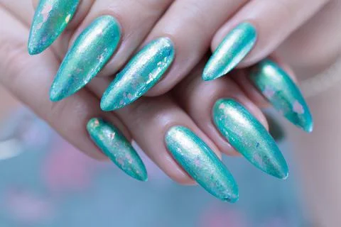 Hand with long nails and light green and blue turquoise manicure 스톡 사진