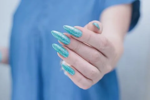 Hand with long nails and light green and blue turquoise manicure Stock Photos