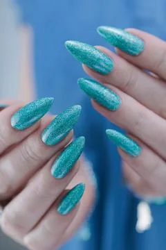 Hand with long nails and light green and blue turquoise manicure Foto stock