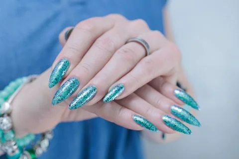 Hand with long nails and light green and blue turquoise manicure Stock Photos