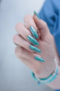 Hand with long nails and light green and blue turquoise manicure Stock Photos