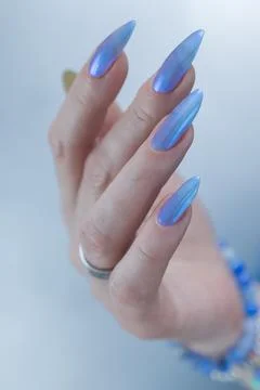 Hand with long nails and light baby blue manicure Stock Photos