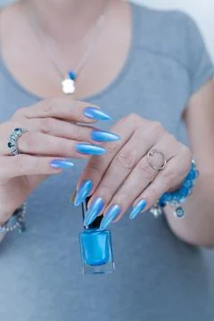 Hand with long nails and light baby blue manicure Stock Photos