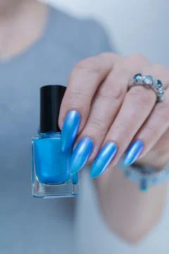 Hand with long nails and light baby blue manicure Stock-Fotos