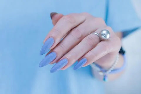 Hand with long nails and light baby blue manicure Stock Photos