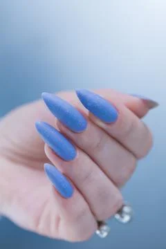 Hand with long nails and light baby blue manicure Stock Photos
