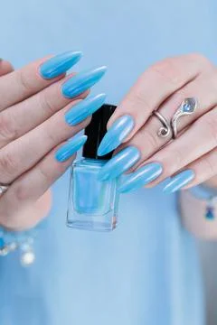 Hand with long nails and light baby blue manicure Stock Photos