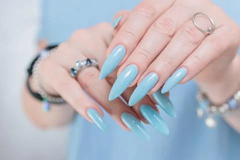 Hand with long nails and light baby blue manicure 스톡 사진