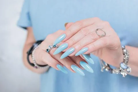 Hand with long nails and light baby blue manicure Foto stock