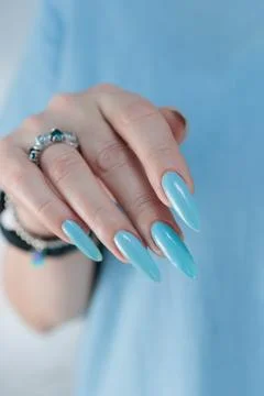 Hand with long nails and light baby blue manicure Stock Photos