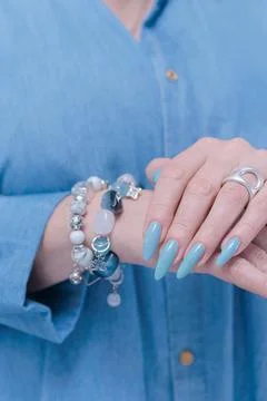 Hand with long nails and light baby blue manicure Stock Photos
