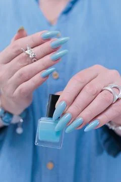Hand with long nails and light baby blue manicure Stock Photos