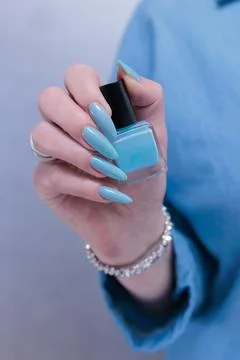 Hand with long nails and light baby blue manicure Stock Photos