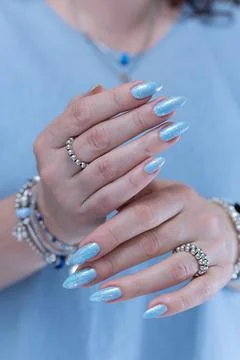 Hand with long nails and light baby blue manicure Stock Photos