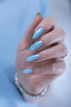 Hand with long nails and light baby blue manicure Foto stock