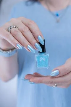 Hand with long nails and light baby blue manicure Foto stock