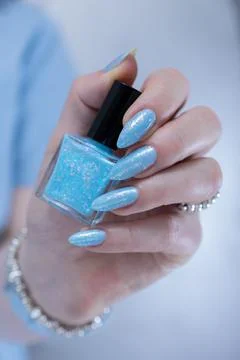 Hand with long nails and light baby blue manicure Stock Photos
