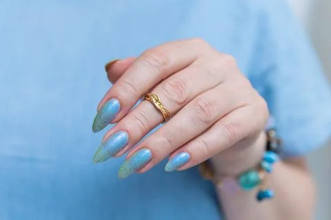 Hand with long nails and light baby blue manicure 库存照片