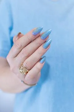 Hand with long nails and light baby blue manicure 스톡 사진