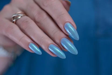 Hand with long nails and light baby blue manicure 库存照片